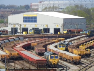 21 Apr 2022 Crewe Basford Hall TMD seen from the far end of the yard with 66556 & 66420 visible in the foreground